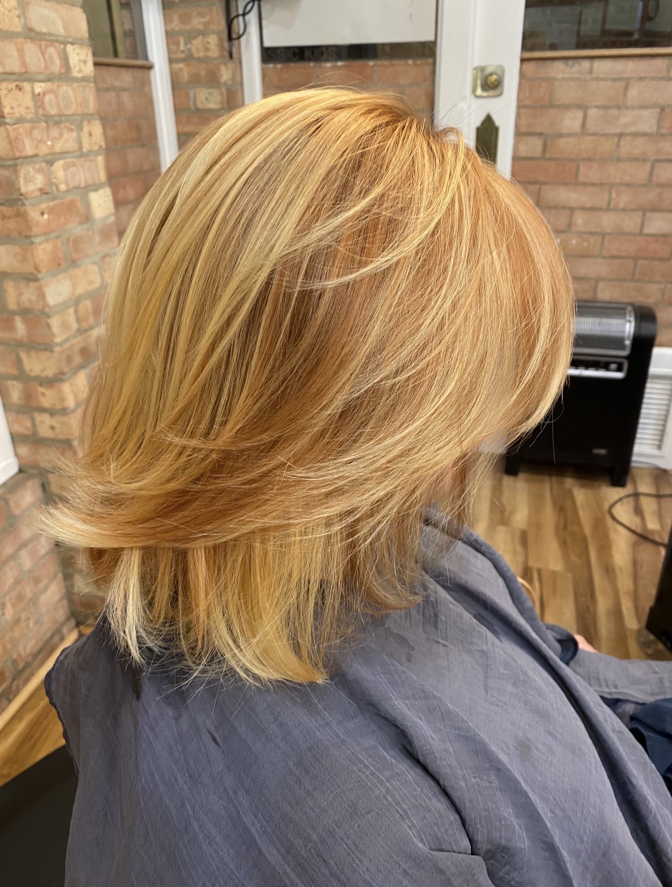 Layered blonde cut with warm highlights